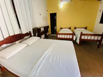 Uma cama ou camas num quarto em Pousada Tropicalia