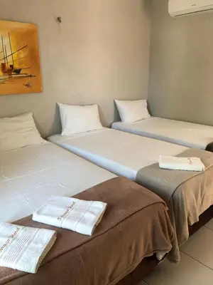 Uma cama ou camas num quarto em Terraço Hotel Lagoinha