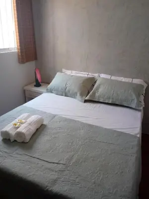 Uma cama ou camas num quarto em Pousada Areia da Praia