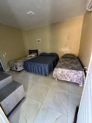 Uma cama ou camas num quarto em Pousada Vó Maria