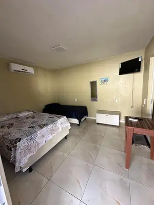 Uma cama ou camas num quarto em Pousada Vó Maria
