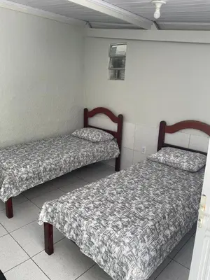 Uma cama ou camas num quarto em Villa Beira Mar Suítes