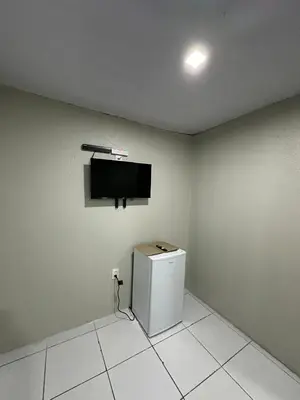 Uma televisão e/ou sistema de entretenimento em Villa Beira Mar Suítes