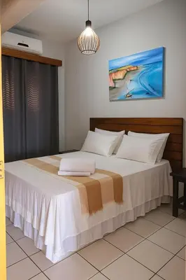 Uma cama ou camas num quarto em Pousada o pescador