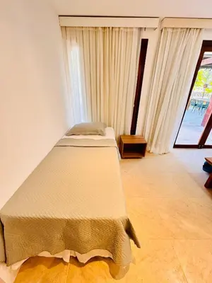Uma cama ou camas num quarto em CASA TAÍBA BEACH RESORT PÉ Na AREIA - IMOB TEMPORADA
