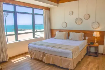 Uma cama ou camas num quarto em Magna Praia Hotel