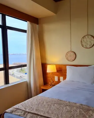 Uma cama ou camas num quarto em Magna Praia Hotel