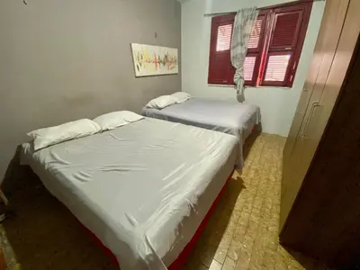 Uma cama ou camas num quarto em Casa 3 Quartos, 50 metros Da Praia