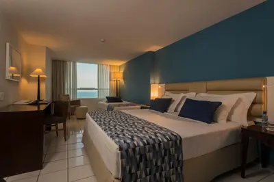 Uma cama ou camas num quarto em Hotel Luzeiros Fortaleza