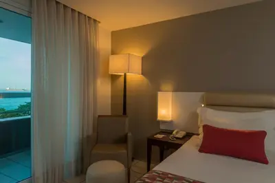 Uma cama ou camas num quarto em Hotel Luzeiros Fortaleza