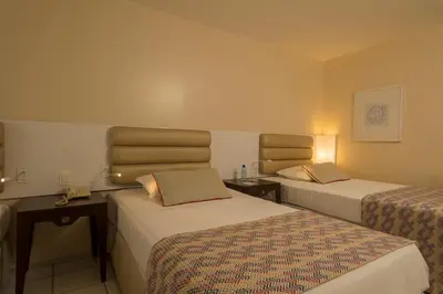 Uma cama ou camas num quarto em Hotel Luzeiros Fortaleza