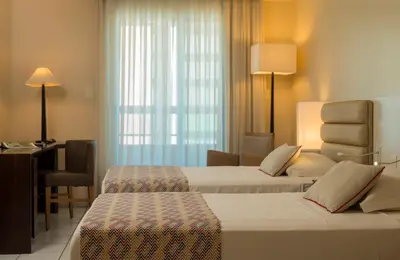 Uma cama ou camas num quarto em Hotel Luzeiros Fortaleza