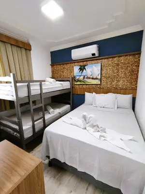 Uma cama ou camas num quarto em Belo apartamento projetado e vista total mar !