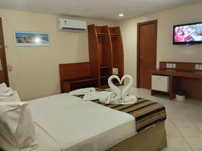 Uma cama ou camas num quarto em Costa do Mar Hotel