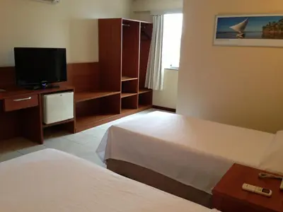 Uma cama ou camas num quarto em Costa do Mar Hotel