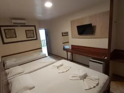 Uma cama ou camas num quarto em Porto Praia Hotel