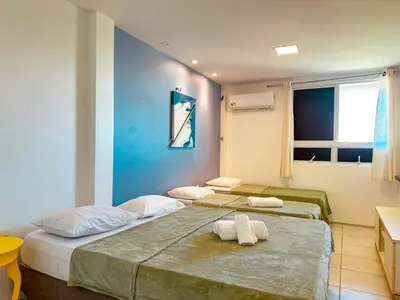 Uma cama ou camas num quarto em Tenha a praia aos seus pés - Apê na Areia com banheira, 2 suítes em condomínio exclusivo com lazer e acesso direto ao mar