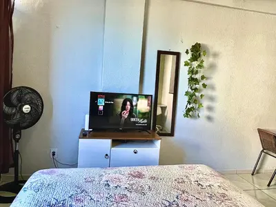 Uma televisão e/ou sistema de entretenimento em Flat Brisa do Mar