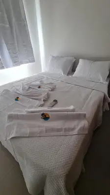 Uma cama ou camas num quarto em Canoa Breeze - Apartment Roof Top
