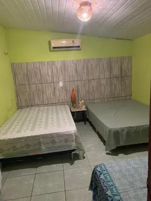 Uma cama ou camas num quarto em Casa na Ilha do Farol