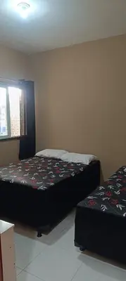 Uma cama ou camas num quarto em Seu lar na Praia