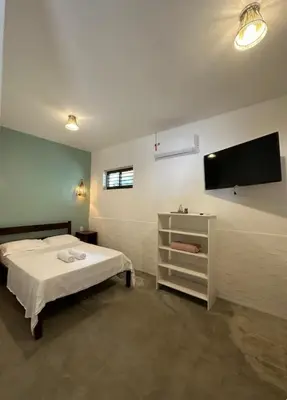 Uma cama ou camas num quarto em Vila Lua Aparts - Apartamento 4