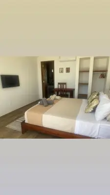 Uma cama ou camas num quarto em Vila éden praia suítes