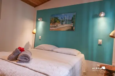 Uma cama ou camas num quarto em Casa Minerva Pontal