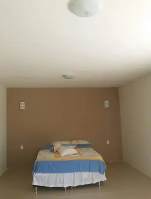 Uma cama ou camas num quarto em Sítio Solar Santa Cecília(Alto Padrão)
