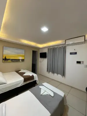 Uma cama ou camas num quarto em Suítes Nativa