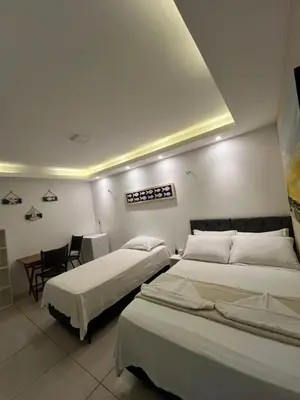 Uma cama ou camas num quarto em Suítes Nativa