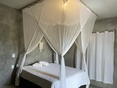 Uma cama ou camas num quarto em Vila Angatu
