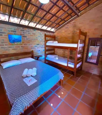Uma cama ou camas num quarto em Pousada Beija-Flor