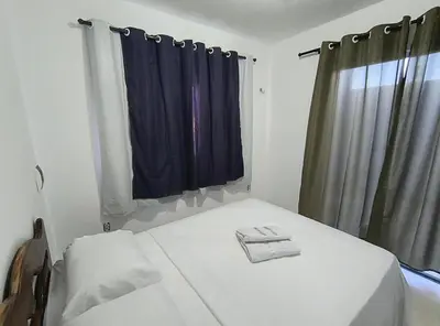 Uma cama ou camas num quarto em Casa Paraiso de Canoa