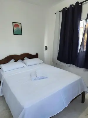 Uma cama ou camas num quarto em Casa Paraiso de Canoa