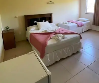 Uma cama ou camas num quarto em Pousada pontal das estrelas