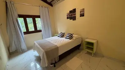 Uma cama ou camas num quarto em Casa Aconchego da Serra - Pacoti