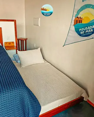 Uma cama ou camas num quarto em Pousada no Mar