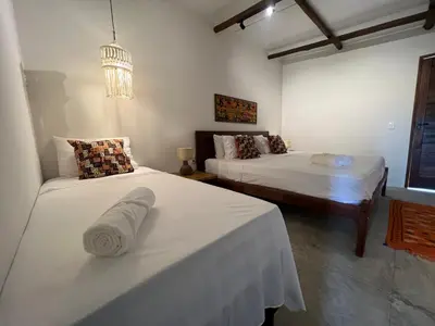 Uma cama ou camas num quarto em Villa Albergaria Icaraizinho