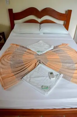 Uma cama ou camas num quarto em Pousada Sitio Phoenix