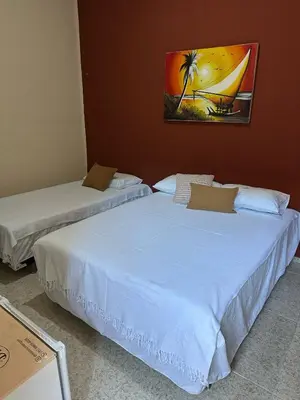 Uma cama ou camas num quarto em Residencial Dragão