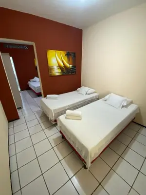 Uma cama ou camas num quarto em Residencial Dragão