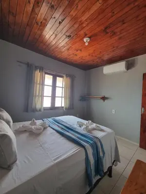 Uma cama ou camas num quarto em Casa sol nascente