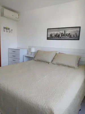 Uma cama ou camas num quarto em Apartamento Porto das Dunas