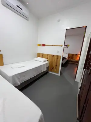 Uma cama ou camas num quarto em Pousada Altas Horas Icaraizinho