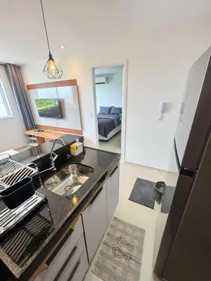 A cozinha ou kitchenette de AP completo próx ao Shopping com piscina, garagem e ar