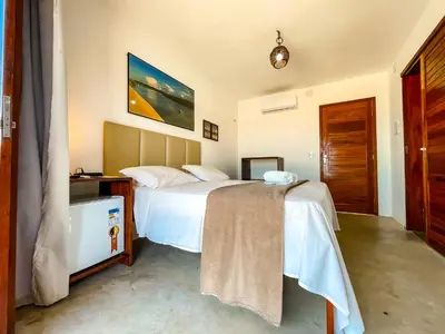 Uma cama ou camas num quarto em Vila Bertini Icaraizinho