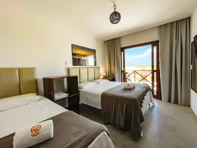 Uma cama ou camas num quarto em Vila Bertini Icaraizinho