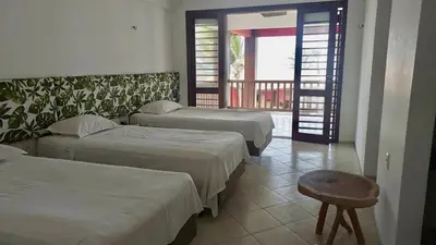 Uma cama ou camas num quarto em Casa pé na areia, com 5 quartos