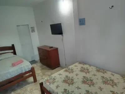 Uma cama ou camas num quarto em Pousada Praiamar